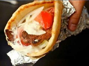 Gyro on pita with tomatoes, onion, and tzatziki